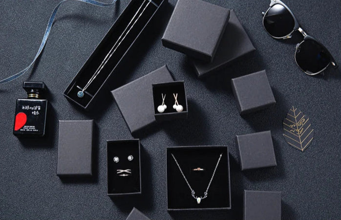 Gift package with jewelry and accessories on a dark surface