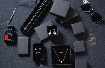 Gift package with jewelry and accessories on a dark surface