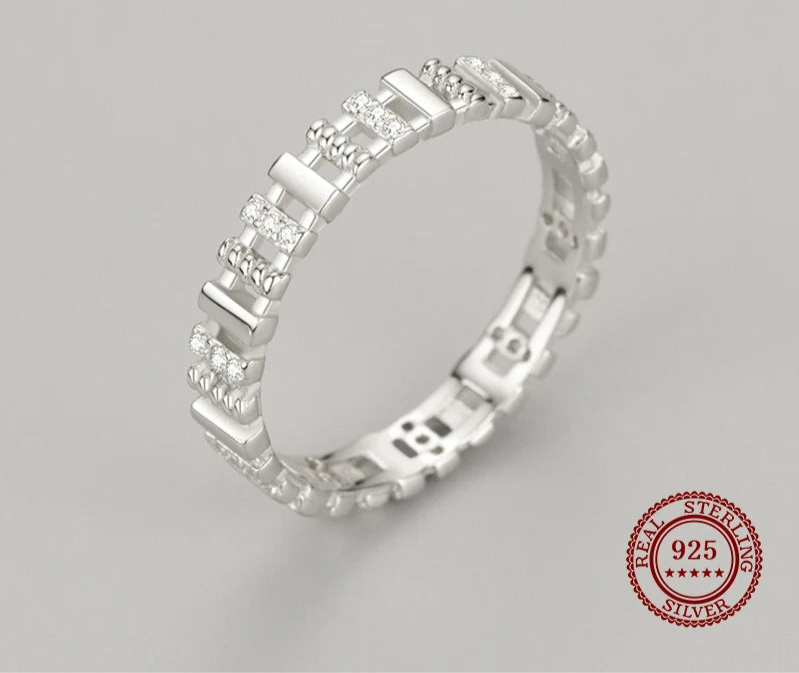 Silver ring with diamonds on a gray background