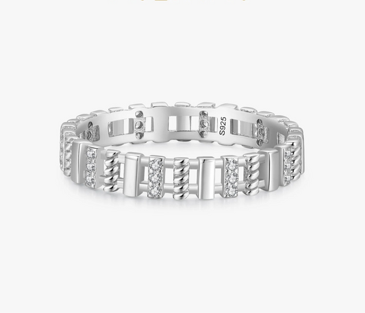 Silver ring with diamond accents on a white background