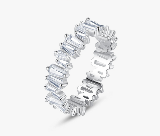 Silver ring with baguette cut stones on a white background